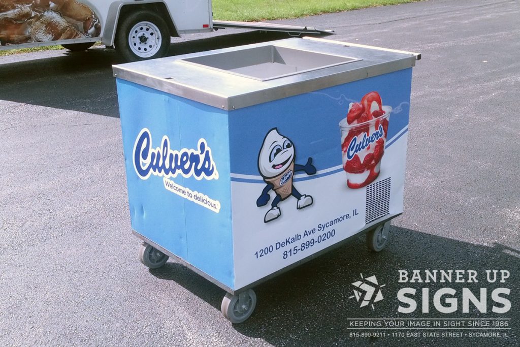 Wrapped in a custom wrap, a Culver's ice cream cart features their mascot Scoopy with a strawberry sundae.