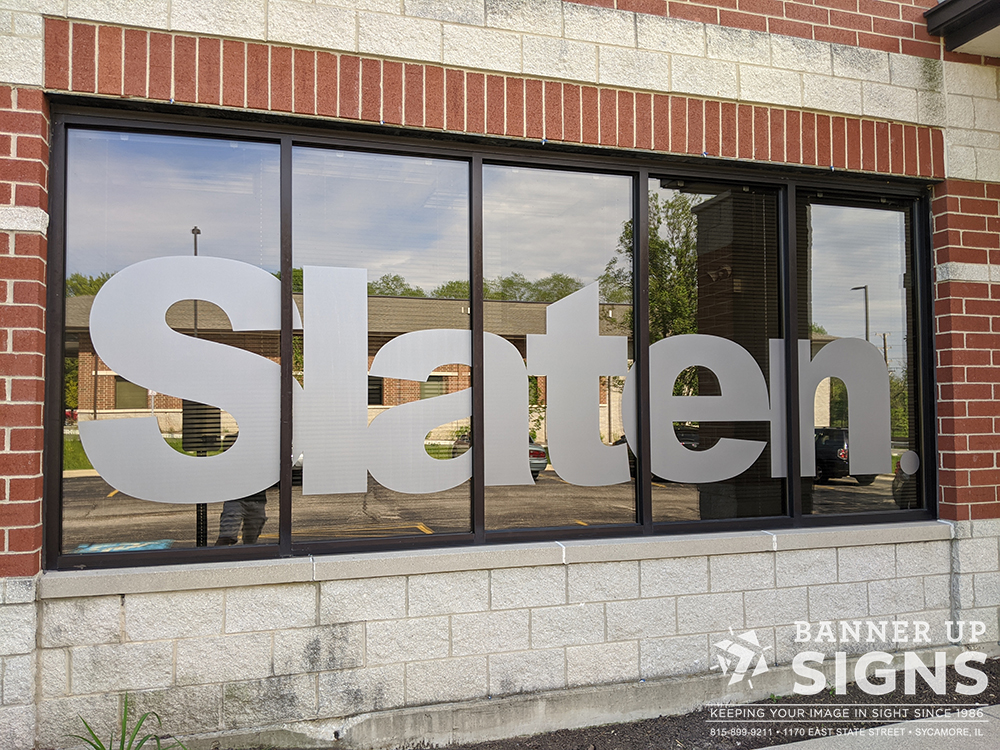 Matte etched vinyl Slaten text on an exterior window pops against the glossy finish.