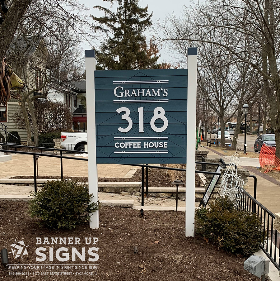 Composed of painted wood posts, wood panel backer, and dimensional text, this unique sign for Graham's Coffee House showcase's one of the many ways Banner Up Signs can customize your business sign to your company's needs.