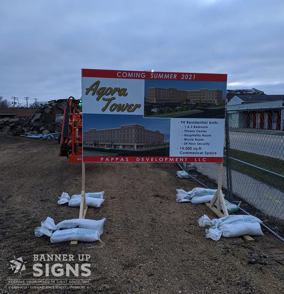 Temp / short term signage from Banner Up Signs announces an upcoming residential development on a construction site.