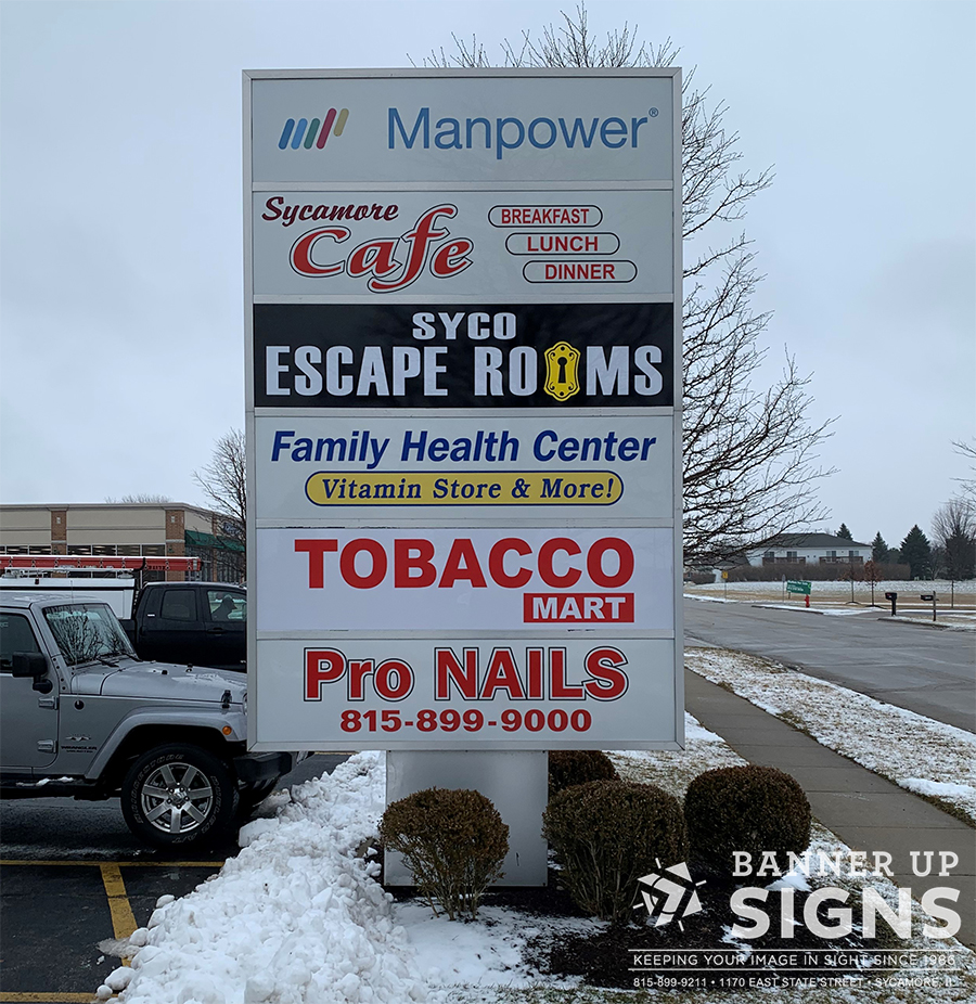 Strip mall signage listing the businesses in that location.