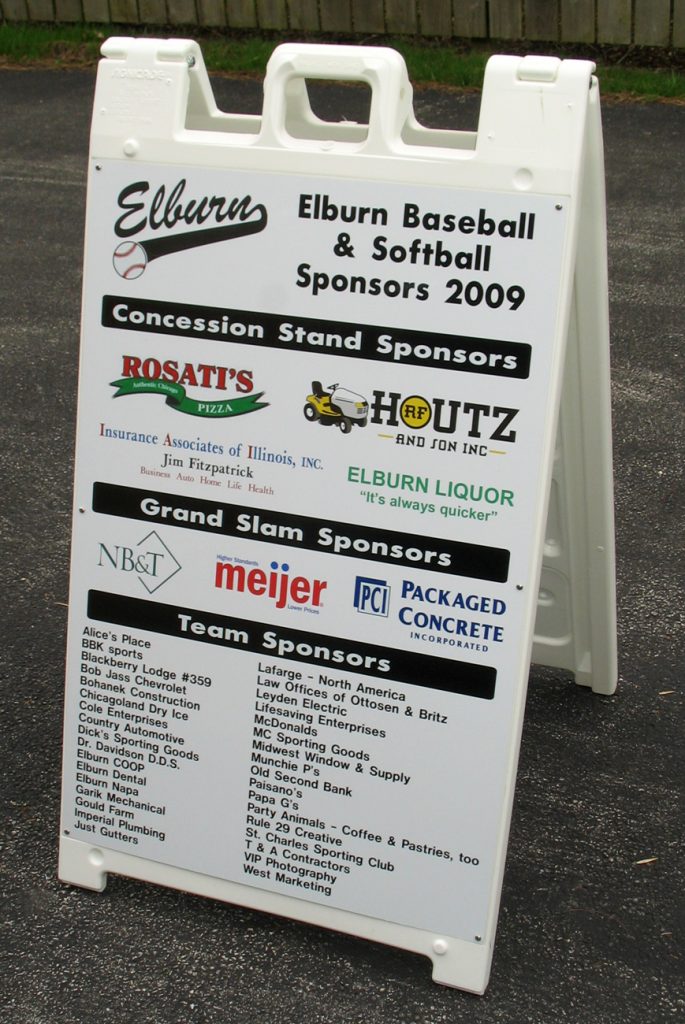 An a-frame sign holder lists local sponsors for the Elburn baseball and softball season.