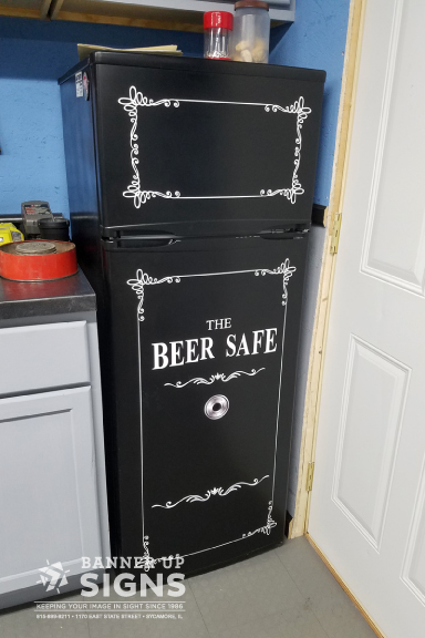 Personalize the fridge in your man cave with a custom 'The Beer Safe' fridge wrap from Banner Up Signs