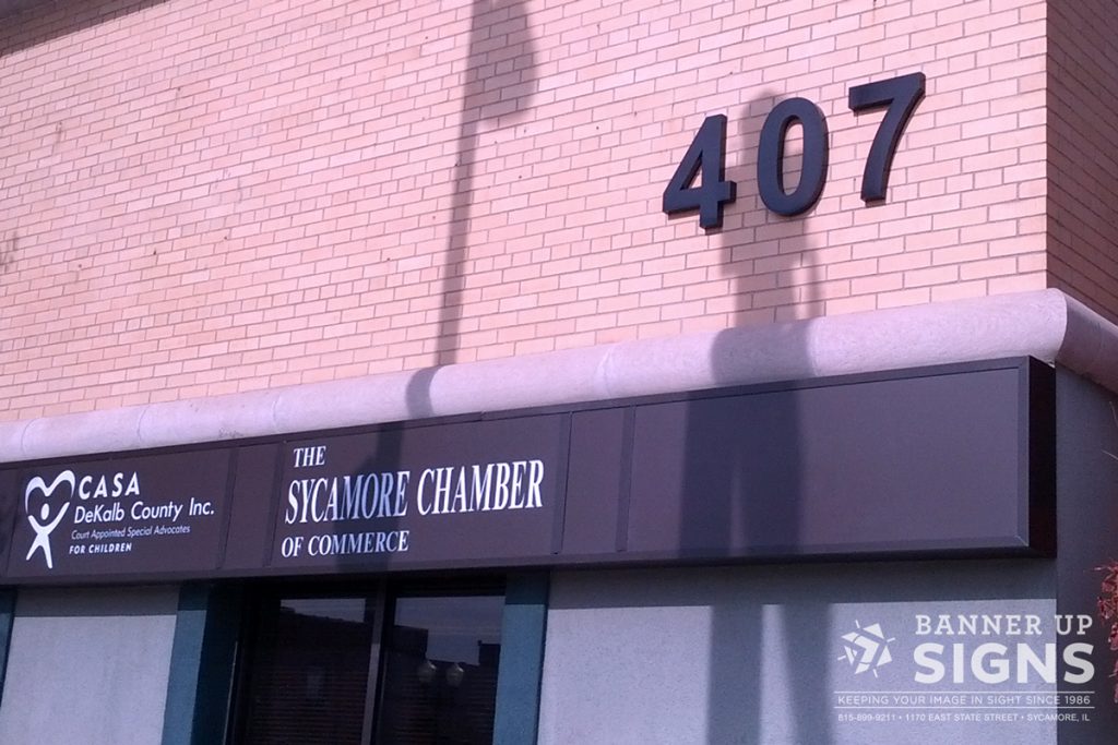 Large dimensional address numbers adorn the side of a building for easy location.