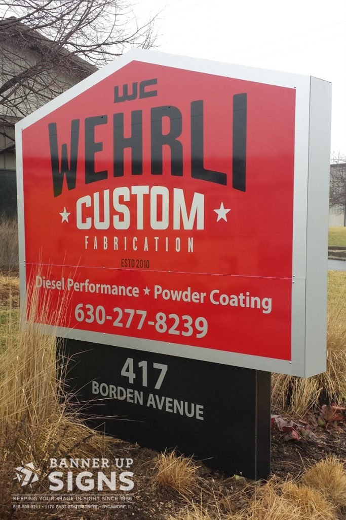 Wehrli Custom's custom shape road sign produced and installed by Banner Up Signs.