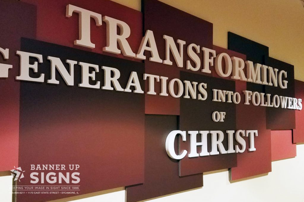 A large multi-dimensional interior sign is installed on the wall with white dimensional text.