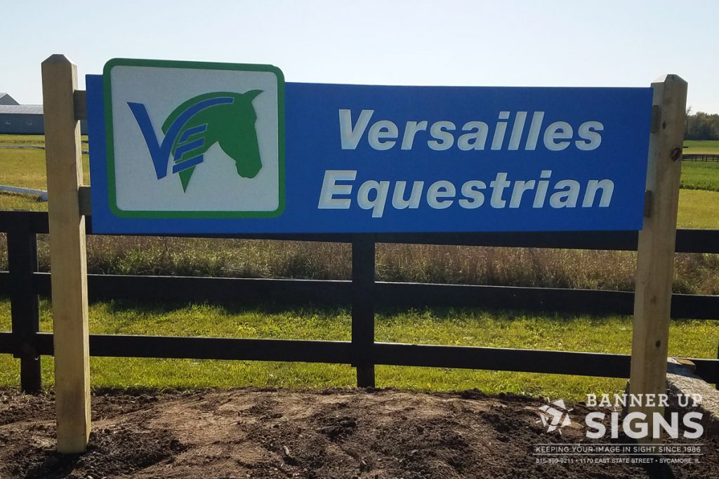 A basic post sign for Versailles Equestrian helps those driving by locate their entrance.