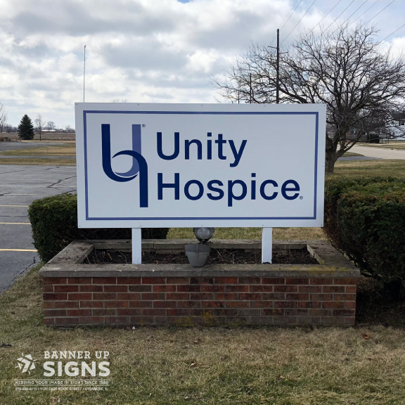 A flat aluminum post sign with non dimensional graphics creates a simple but impactful sign for Unity Hospice.