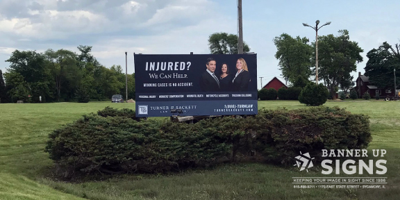 A large post sign acts as a billboard for injury lawyers.
