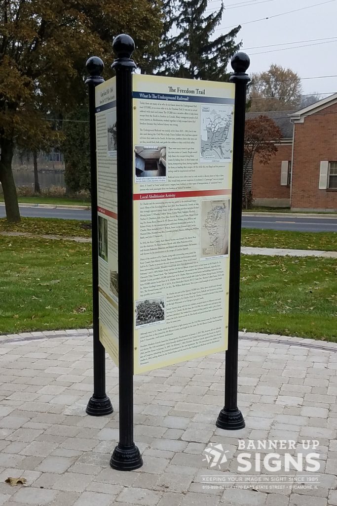 A large triangle post sign shares information about the history of the location it is in.