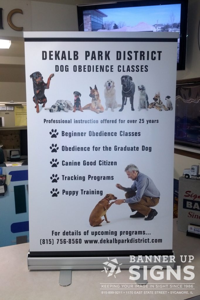 DeKalb Park District uses a table top retractor to showcase dog obedience classes they have offered.
